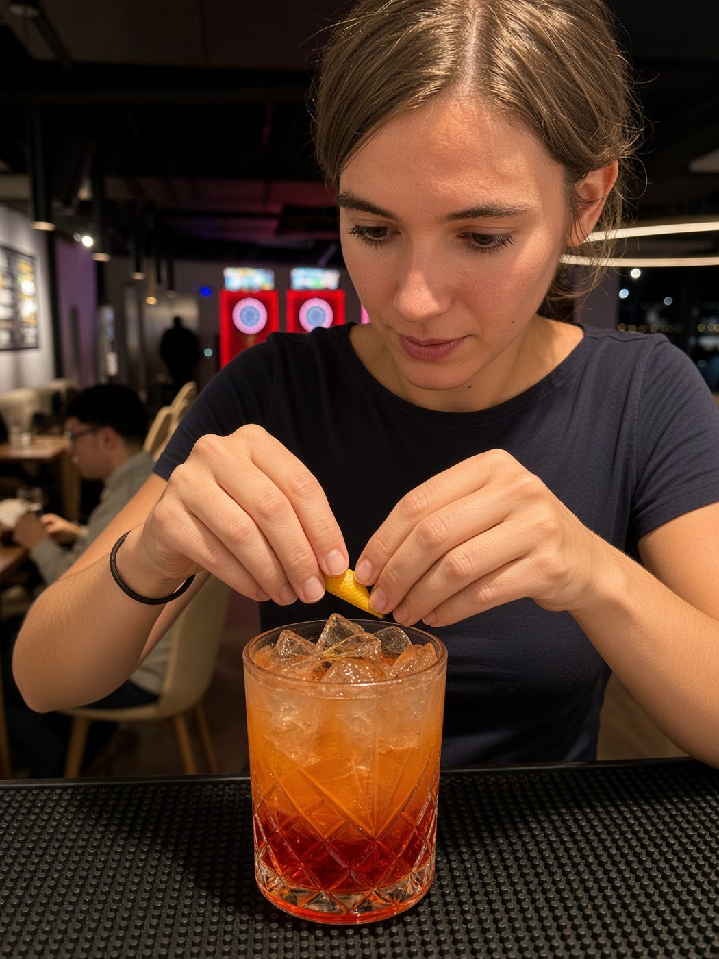 A guest adds a garnish to her cocktail